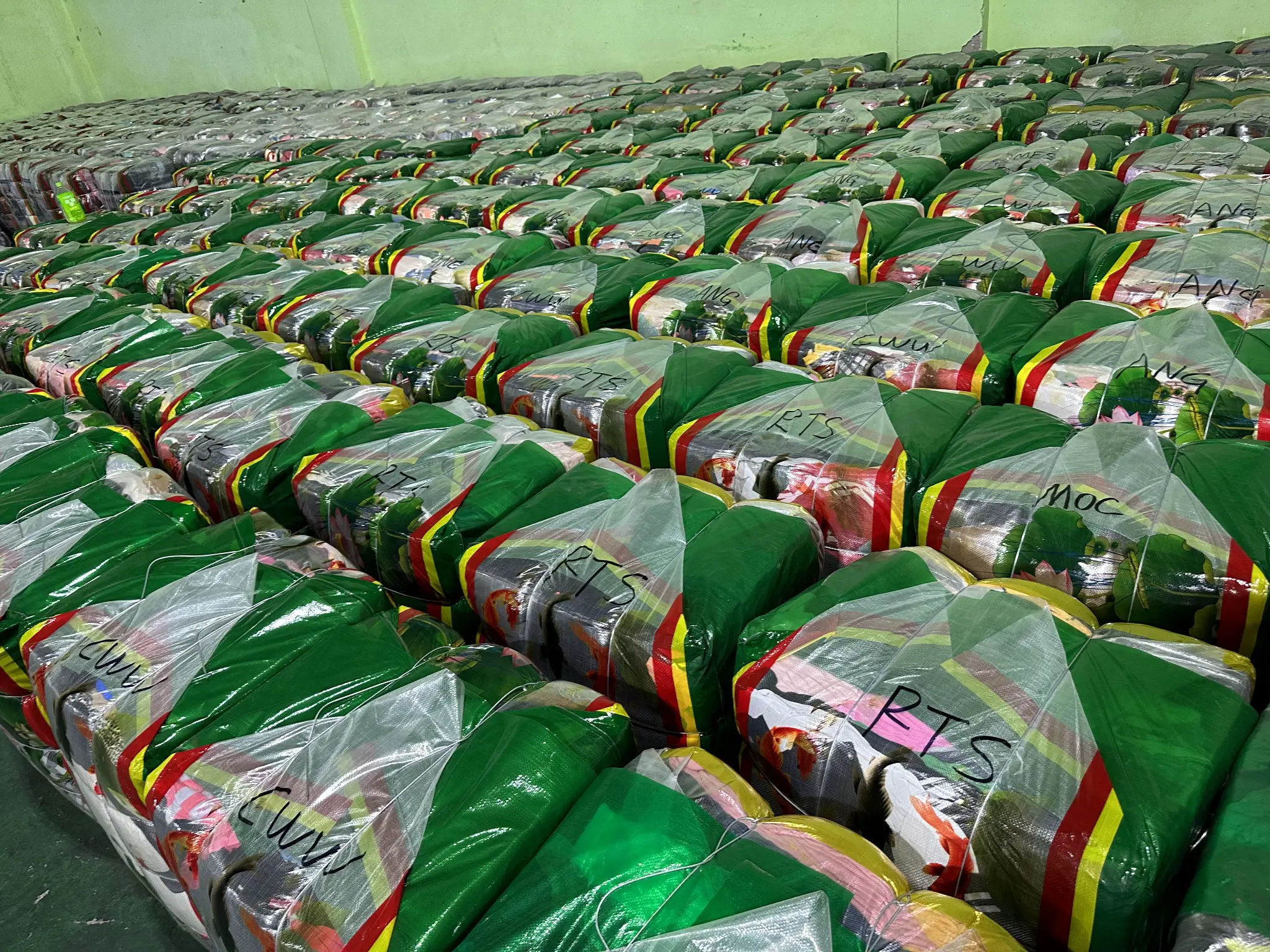 Factory warehouse with stacked clothing bales